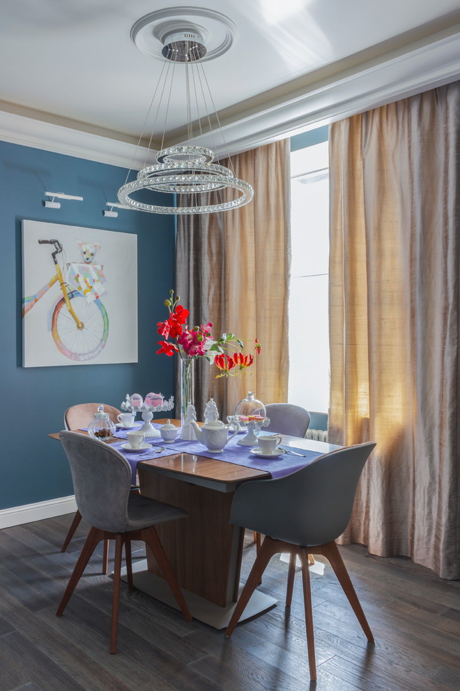 Стильный дизайн: кухня-столовая в современном стиле с синими стенами и темным паркетным полом - последний тренд