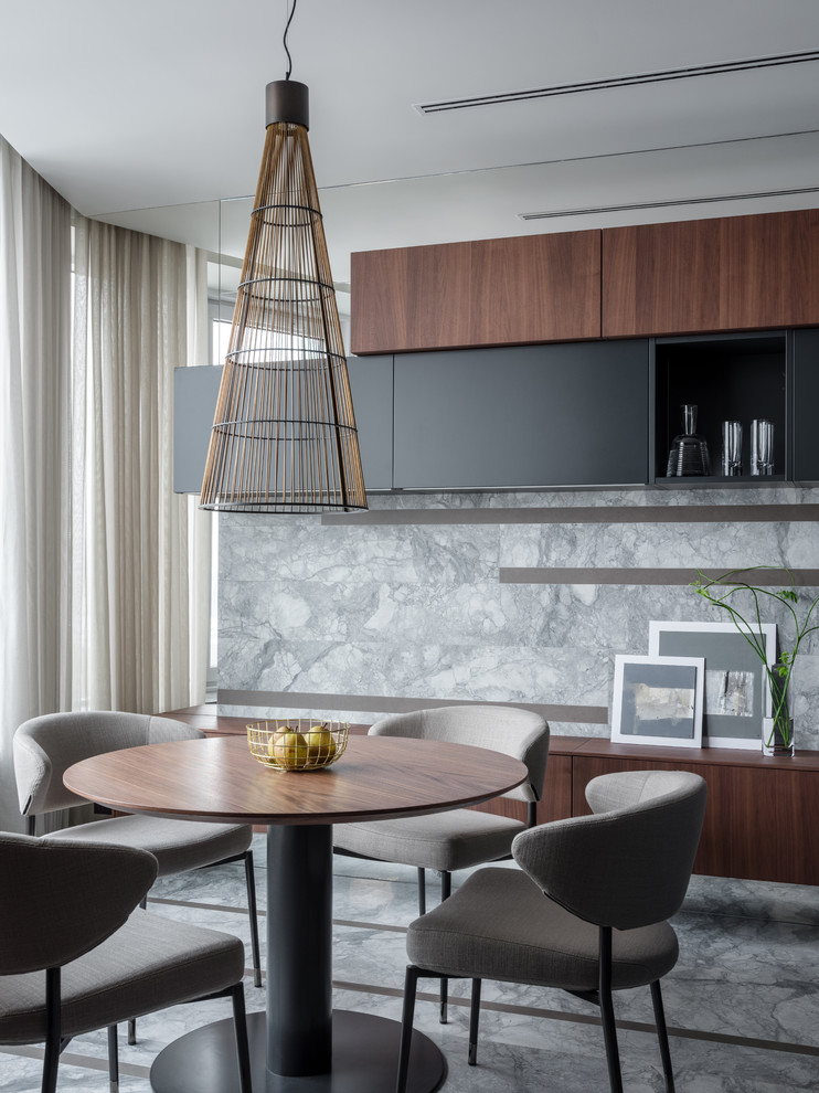 This is an example of a contemporary kitchen/dining room in Moscow with grey walls and grey floors.
