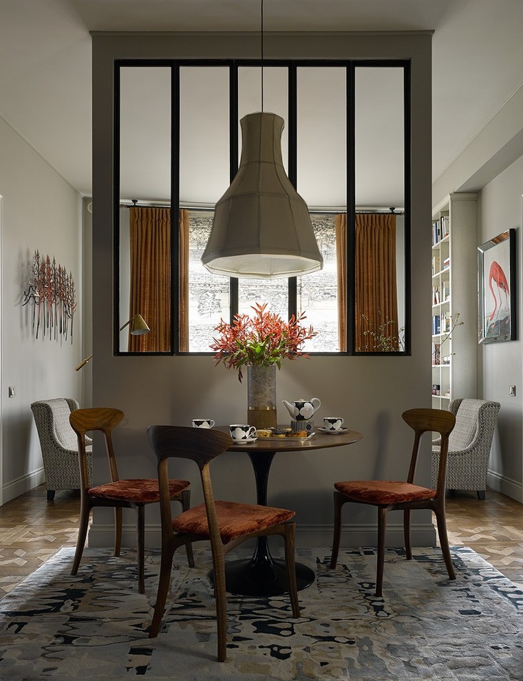 Inspiration pour une salle à manger ouverte sur le salon minimaliste avec un mur gris, un sol en bois brun et un sol marron.