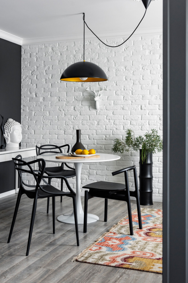 Medium sized contemporary dining room in Yekaterinburg with white walls, grey floors and brick walls.