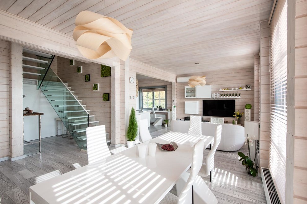 Inspiration for a contemporary open plan dining room in Moscow with light hardwood flooring and no fireplace.