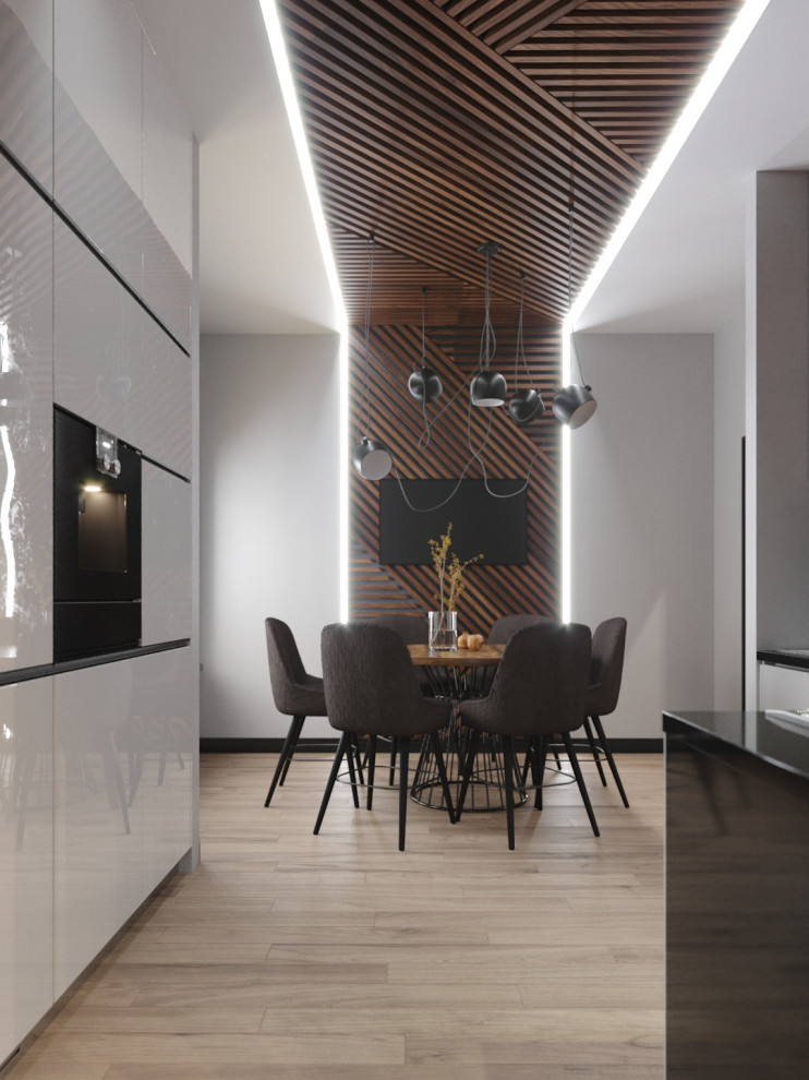 This is an example of a medium sized contemporary kitchen/dining room in Moscow with white walls, light hardwood flooring and beige floors.