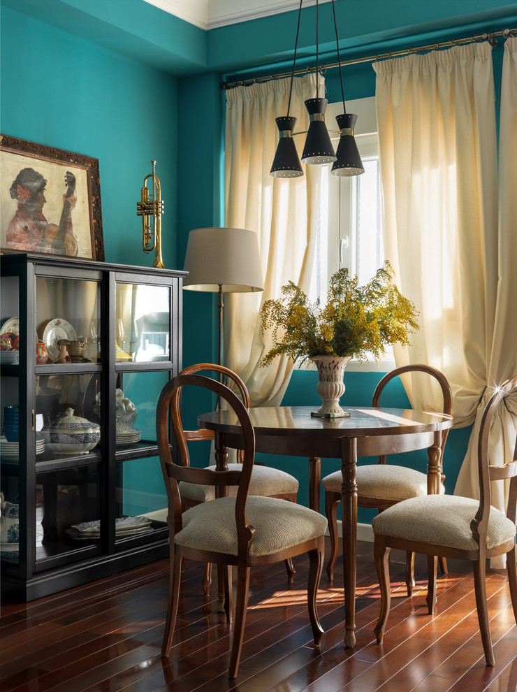 Photo of an eclectic dining room in Moscow with blue walls, medium hardwood flooring, brown floors and feature lighting.