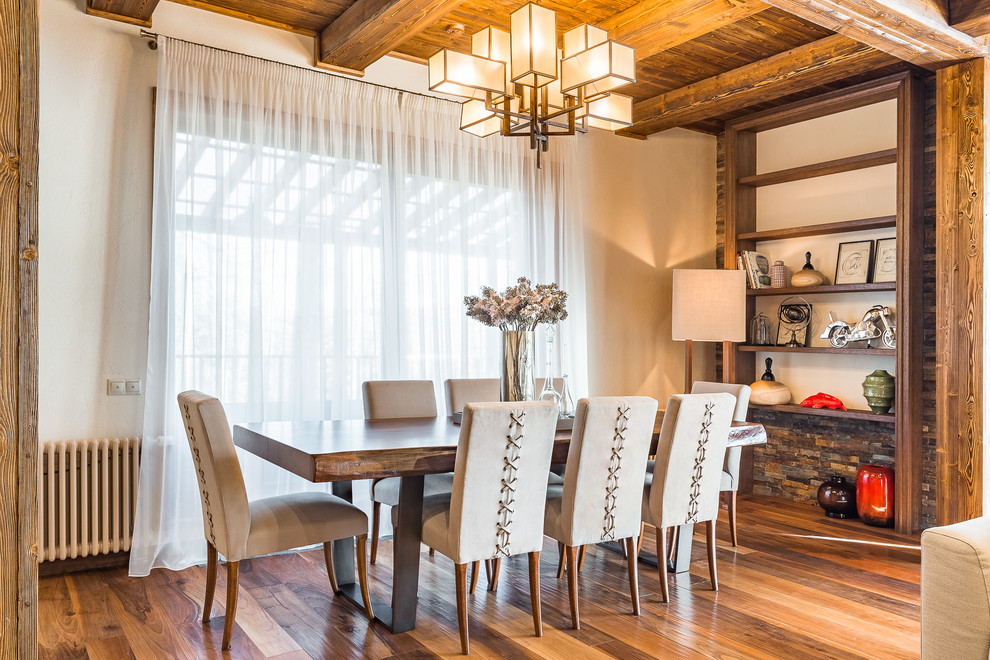Rural open plan dining room in Moscow with white walls, medium hardwood flooring, brown floors and feature lighting.