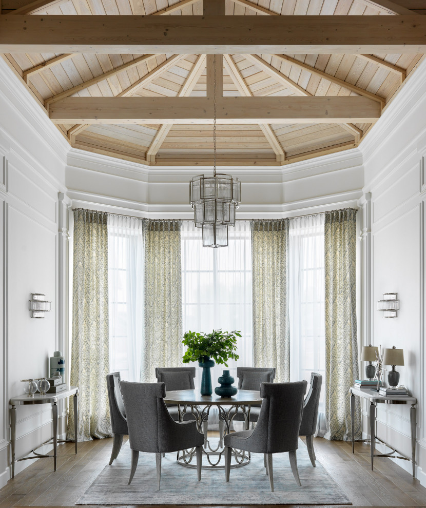 This is an example of a traditional dining room in Other with white walls, brown floors and a vaulted ceiling.