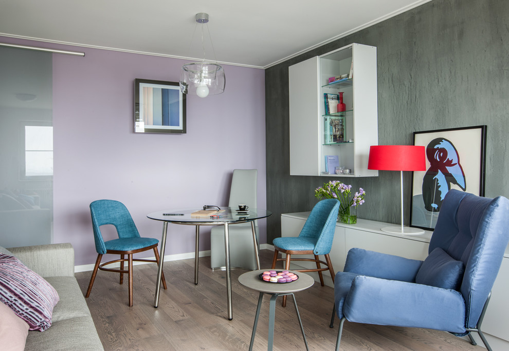 Пример оригинального дизайна: маленькая гостиная-столовая в современном стиле с разноцветными стенами и светлым паркетным полом для на участке и в саду