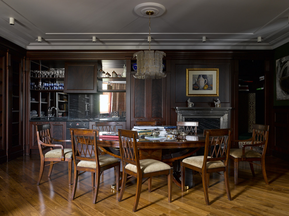 Example of a classic medium tone wood floor and brown floor dining room design in Moscow with brown walls and a standard fireplace