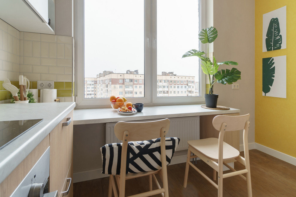 На фото: столовая среднего размера в современном стиле с с кухонным уголком, желтыми стенами, полом из винила, коричневым полом и обоями на стенах