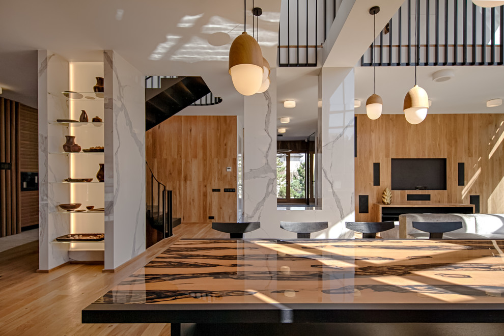 Пример оригинального дизайна: большая гостиная-столовая в современном стиле с коричневыми стенами, паркетным полом среднего тона и коричневым полом