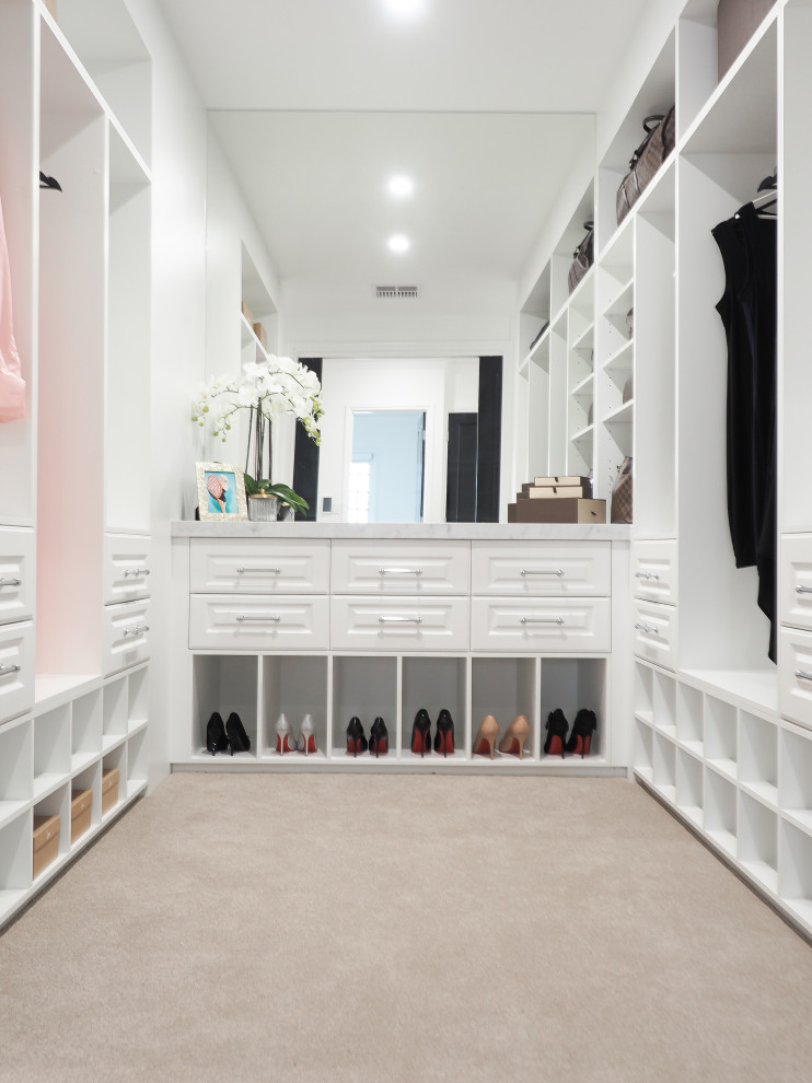 This is an example of a small contemporary walk-in wardrobe in Brisbane with shaker cabinets, white cabinets and carpet.