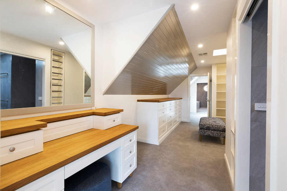 Inspiration for a large contemporary gender neutral walk-in wardrobe in Melbourne with white cabinets, carpet and recessed-panel cabinets.