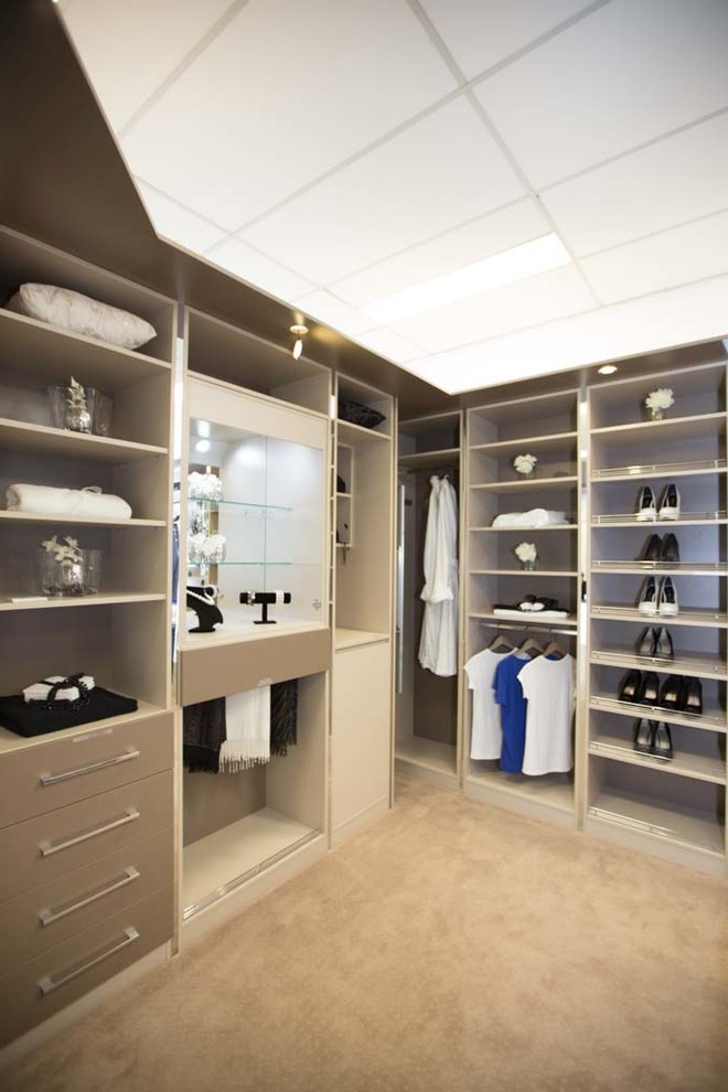 Huge trendy women's carpeted dressing room photo in Perth with open cabinets and gray cabinets