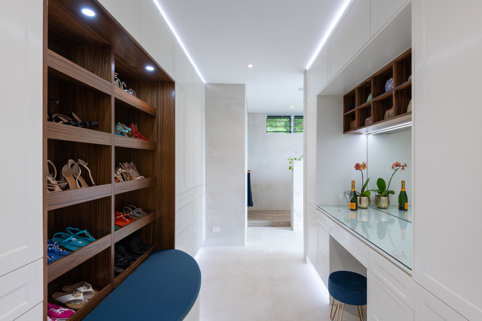 Photo of a large contemporary gender neutral walk-in wardrobe in Cairns with shaker cabinets, yellow cabinets, porcelain flooring and beige floors.