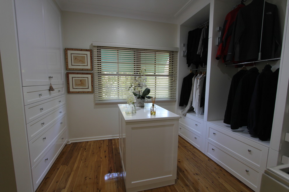 Walk-in closet - mid-sized traditional gender-neutral light wood floor walk-in closet idea in Sydney with shaker cabinets and white cabinets