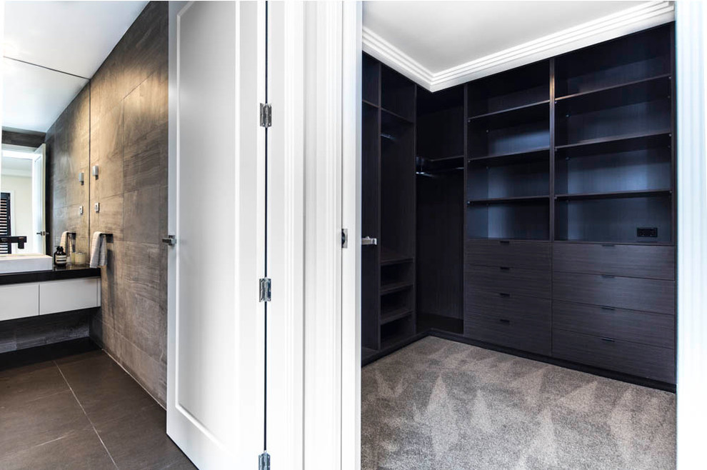 Walk-in closet - mid-sized contemporary gender-neutral carpeted walk-in closet idea in Brisbane with flat-panel cabinets and dark wood cabinets