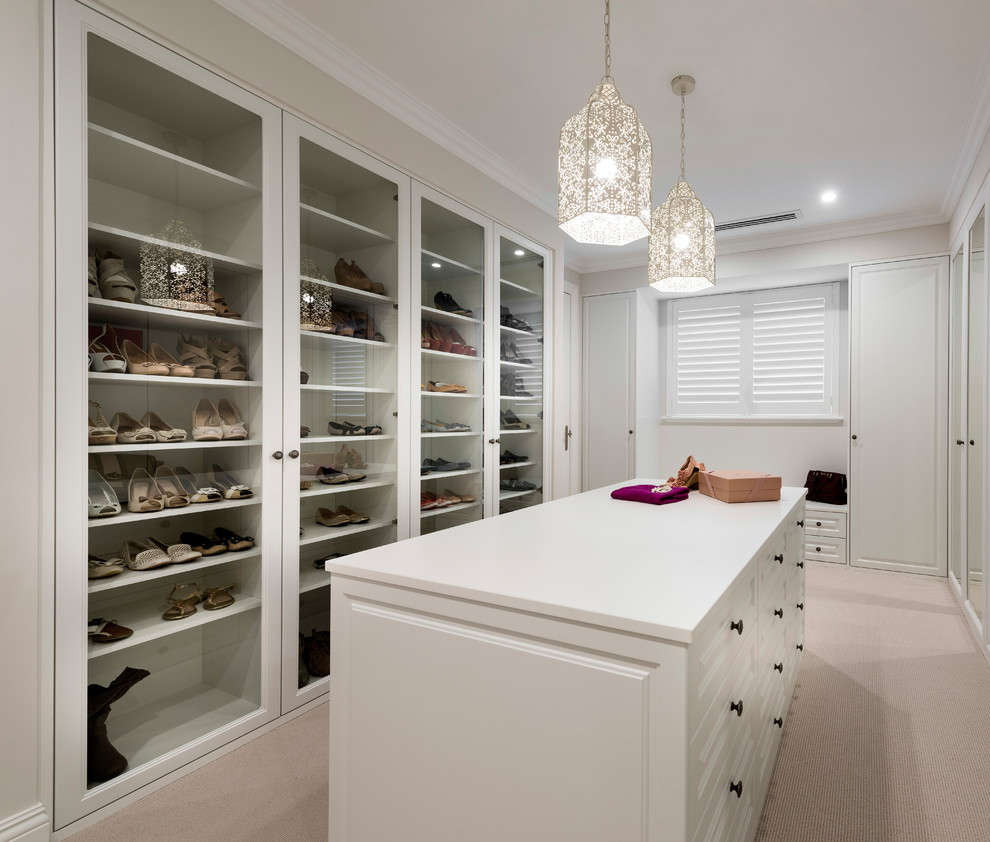 Traditional dressing room for women in Perth with glass-front cabinets, white cabinets, carpet and beige floors.