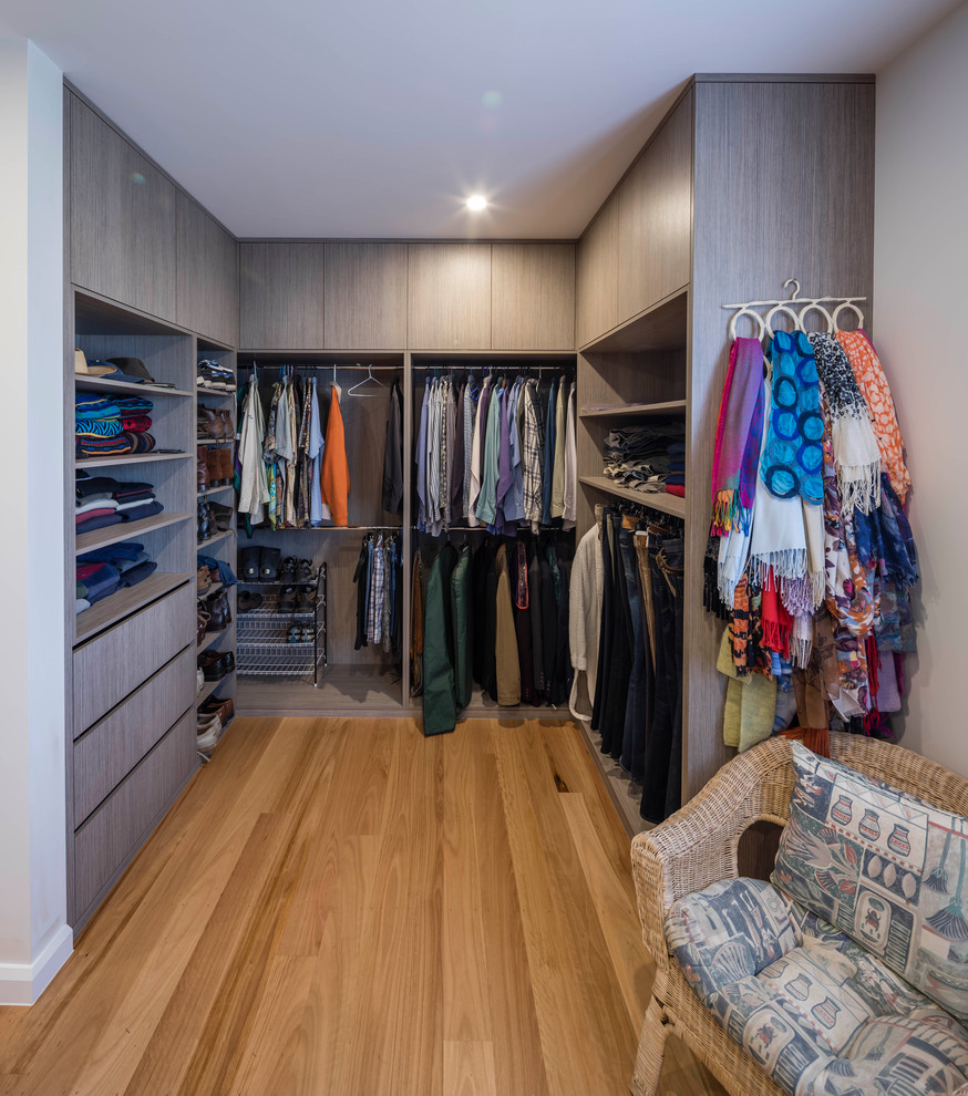 Huge trendy light wood floor and brown floor dressing room photo in Sydney with light wood cabinets