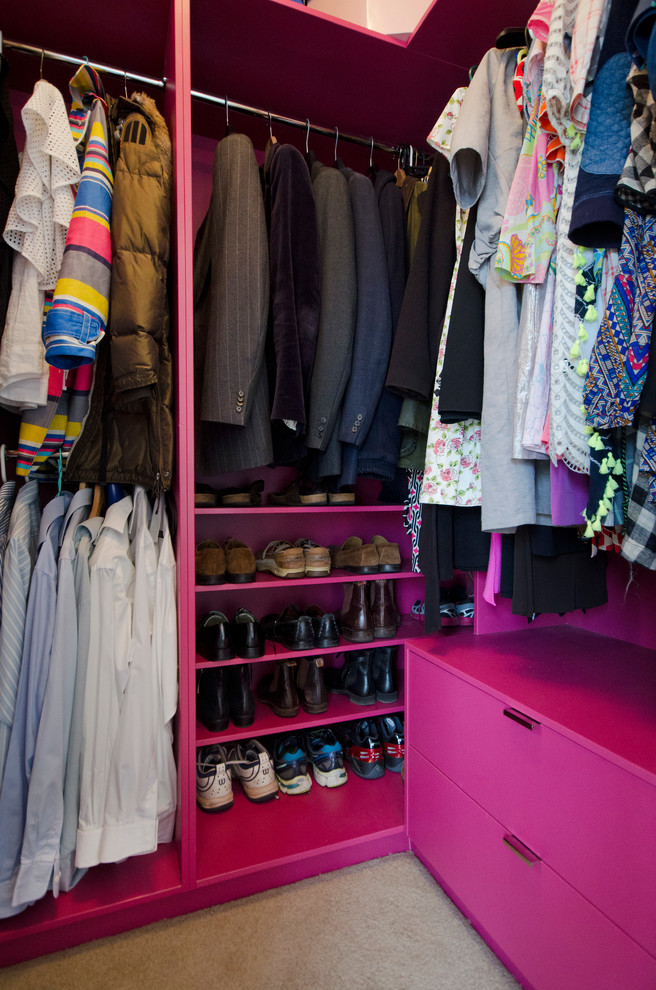 Photo of a medium sized contemporary gender neutral walk-in wardrobe in Melbourne with flat-panel cabinets, red cabinets, carpet and beige floors.