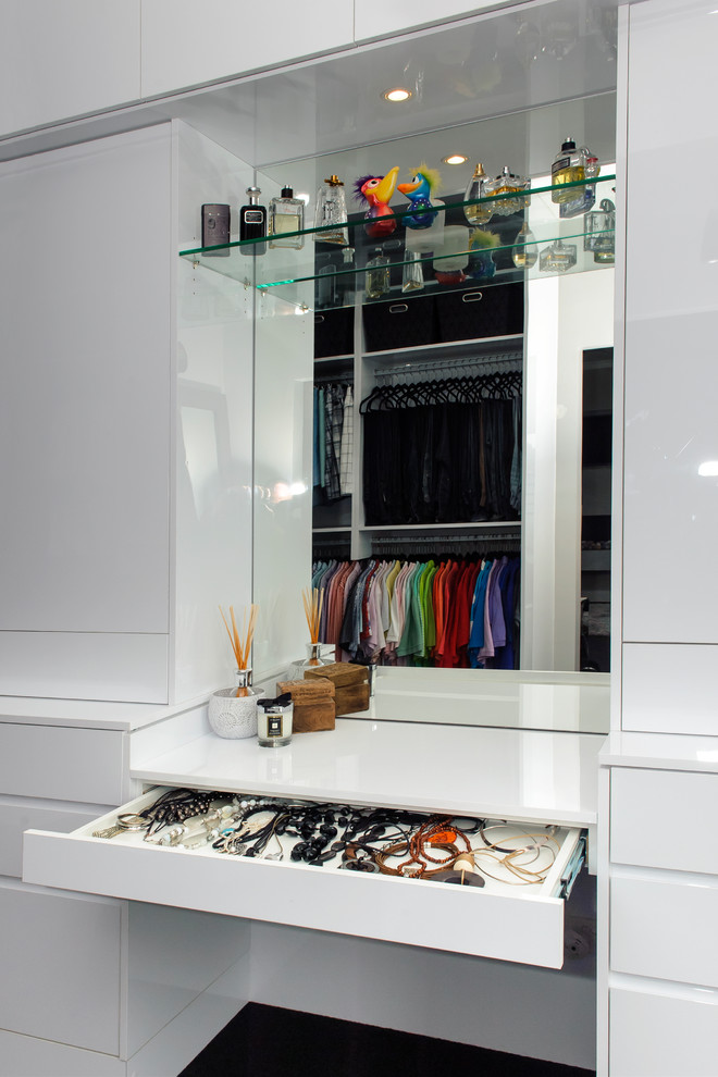 This is an example of a contemporary wardrobe for women in Sydney with flat-panel cabinets and white cabinets.