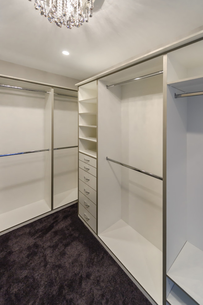 Inspiration for an expansive modern walk-in wardrobe for women in Melbourne with open cabinets, white cabinets and carpet.