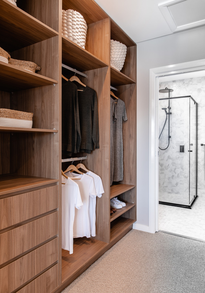 Inspiration for a contemporary carpeted and gray floor walk-in closet remodel in Sydney with open cabinets and medium tone wood cabinets