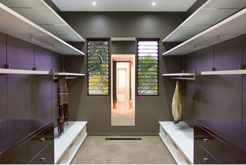 На фото: гардеробная комната среднего размера, унисекс в восточном стиле с ковровым покрытием