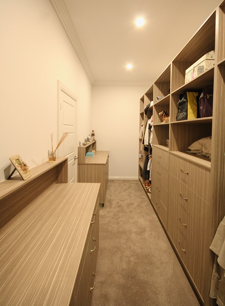 Inspiration for a large classic gender neutral walk-in wardrobe in Sydney with flat-panel cabinets, light wood cabinets, carpet and grey floors.