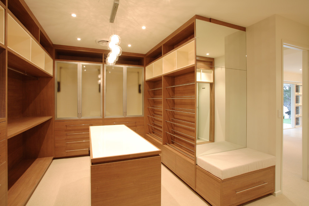 Inspiration for a mid-sized contemporary gender-neutral dressing room remodel in Brisbane with medium tone wood cabinets