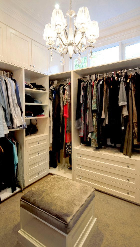 Inspiration for a large timeless gender-neutral carpeted and beige floor walk-in closet remodel in Melbourne with white cabinets and recessed-panel cabinets