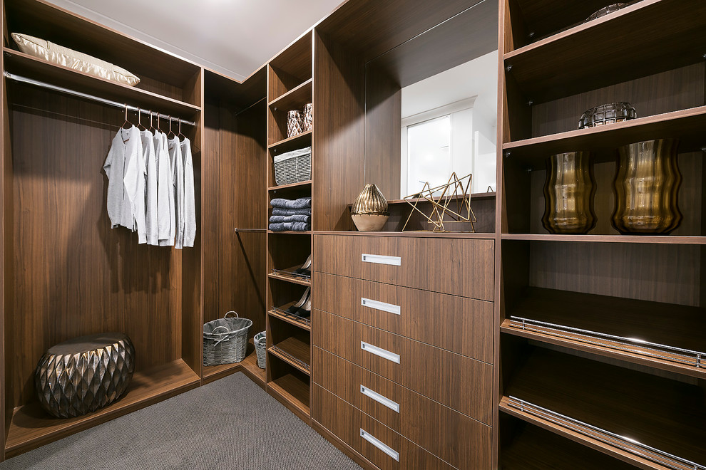 This is an example of a medium sized contemporary gender neutral dressing room in Perth with medium wood cabinets and carpet.