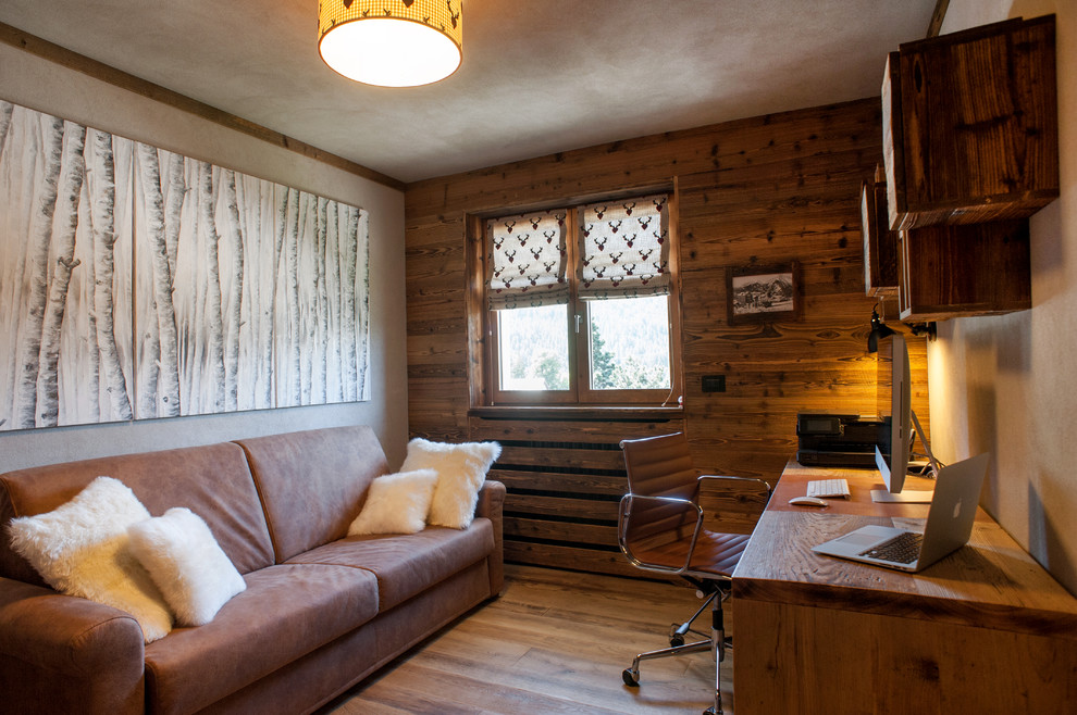 Photo of a medium sized rustic home studio in Turin with multi-coloured walls, no fireplace, a freestanding desk and medium hardwood flooring.