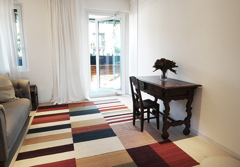 ミラノにあるラグジュアリーな広いコンテンポラリースタイルのおしゃれなホームオフィス・書斎 (白い壁、ラミネートの床、グレーの床) の写真