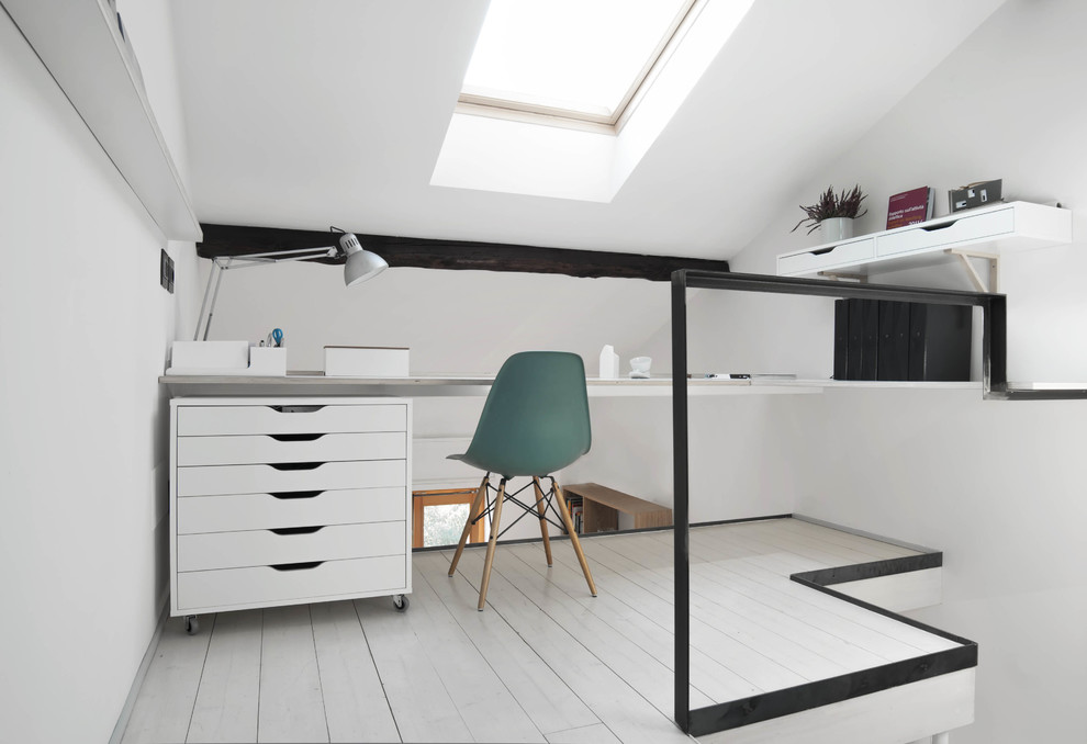 Exempel på ett litet minimalistiskt hemmastudio, med vita väggar, målat trägolv och ett fristående skrivbord
