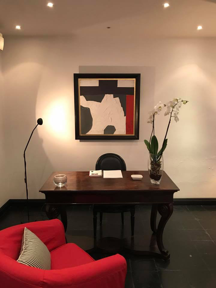 Kleines Mid-Century Arbeitszimmer mit Studio, beiger Wandfarbe, Terrakottaboden, freistehendem Schreibtisch und schwarzem Boden in Rom