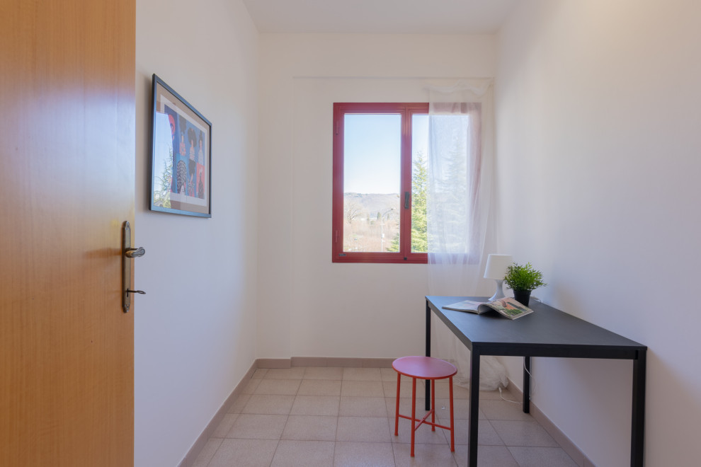 Immagine di una piccola stanza da lavoro minimalista con pareti bianche, pavimento in gres porcellanato, scrivania autoportante e pavimento beige