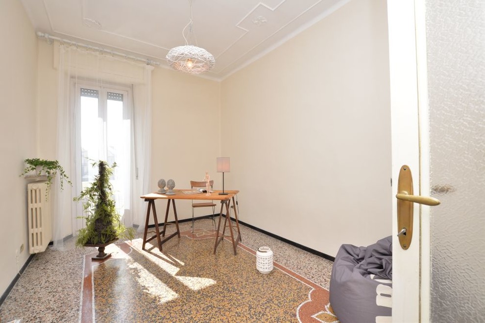 Medium sized traditional home studio in Other with beige walls and multi-coloured floors.