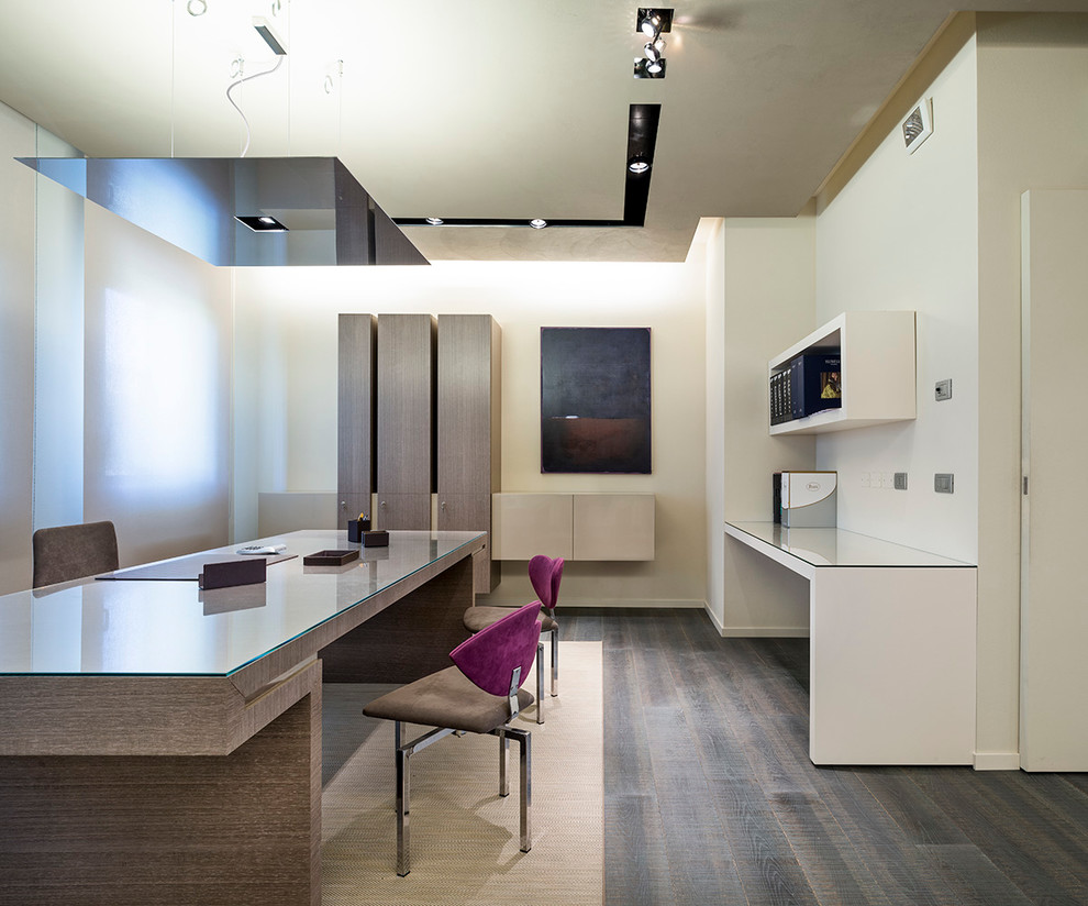 Foto de despacho contemporáneo extra grande sin chimenea con paredes multicolor, suelo de madera oscura y escritorio independiente