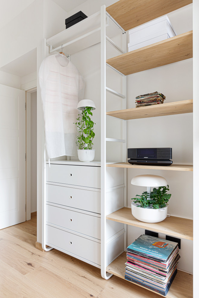 Small scandi home office in Milan with a reading nook, white walls, light hardwood flooring, a freestanding desk and a drop ceiling.