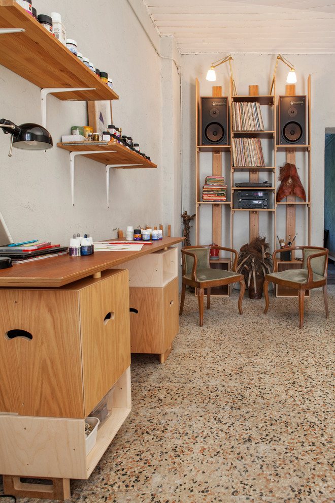 ミラノにあるお手頃価格の広い北欧スタイルのおしゃれなアトリエ・スタジオ (白い壁、大理石の床、標準型暖炉、漆喰の暖炉まわり、自立型机、マルチカラーの床) の写真