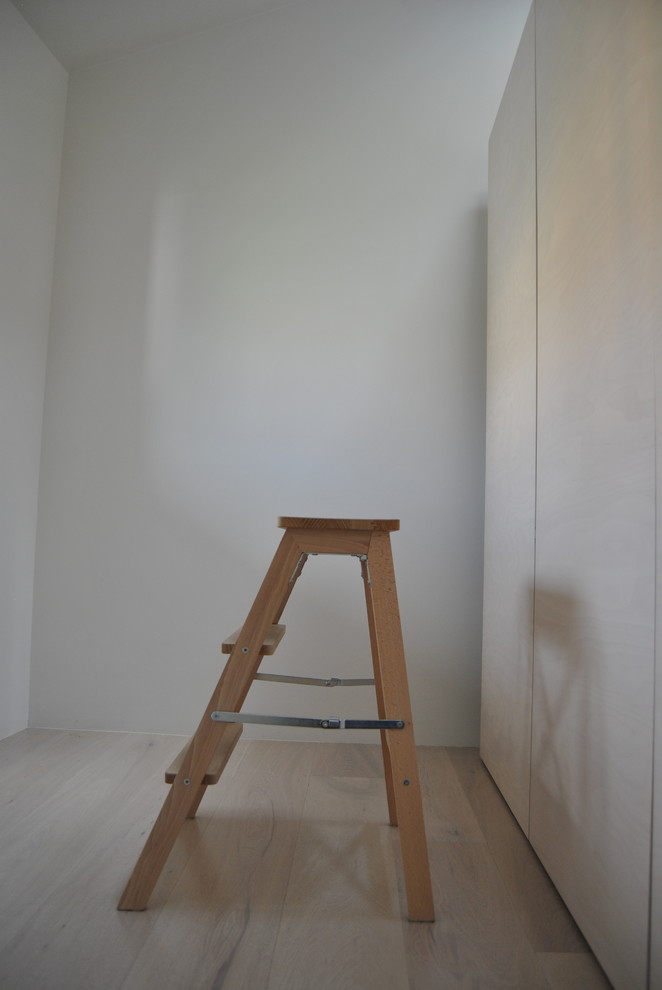 Inspiration för små moderna hemmastudior, med vita väggar, ljust trägolv, ett fristående skrivbord och beiget golv
