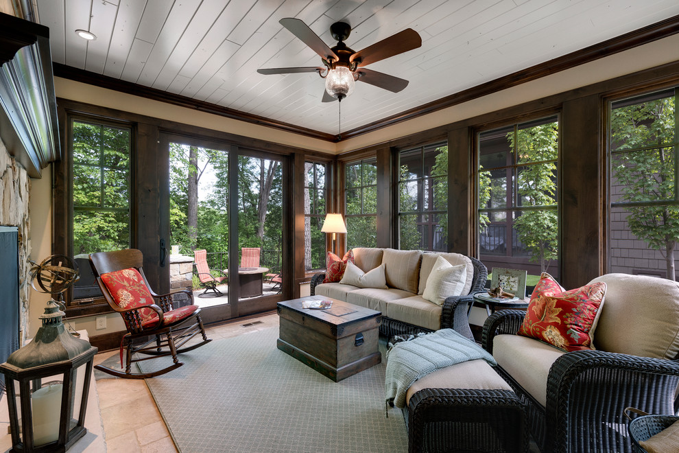 This is an example of a large rustic conservatory in Minneapolis with ceramic flooring, a stone fireplace surround and a standard ceiling.