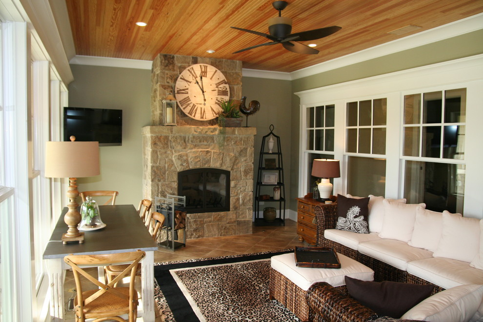 This is an example of a traditional conservatory in Chicago with a stone fireplace surround and a standard ceiling.