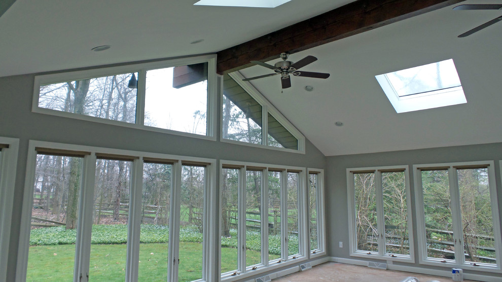 Large classic conservatory in Cleveland with no fireplace and a skylight.