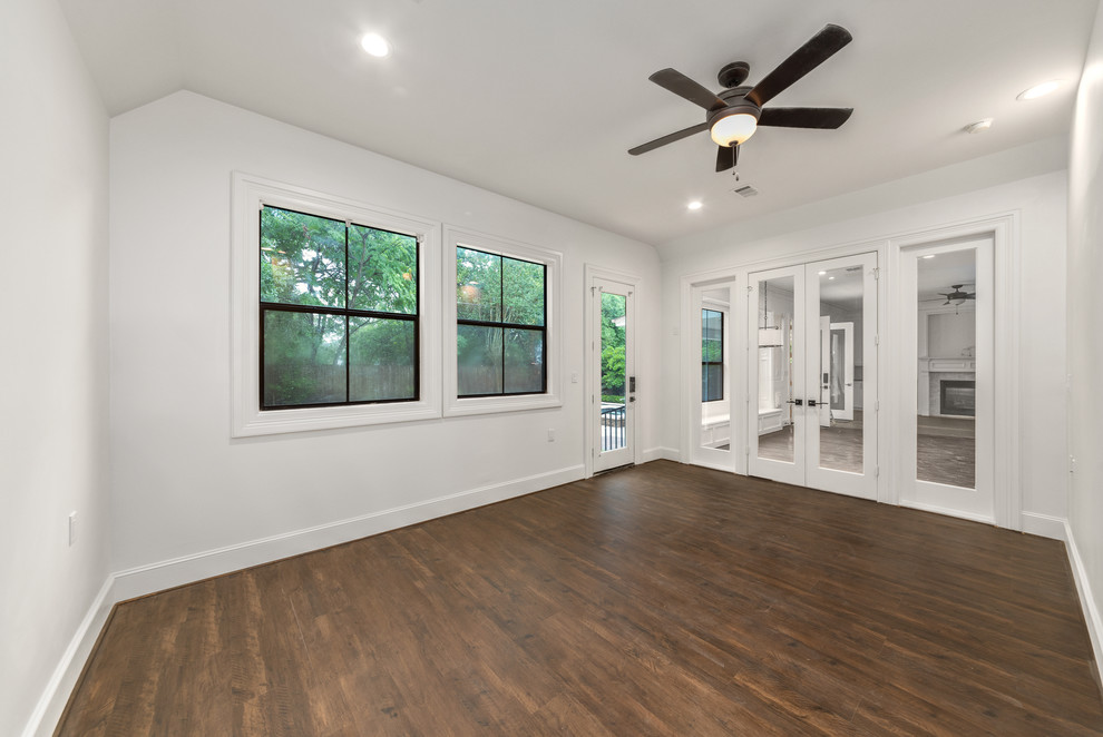 Photo of a large traditional conservatory in Houston with laminate floors, brown floors, no fireplace and a standard ceiling.