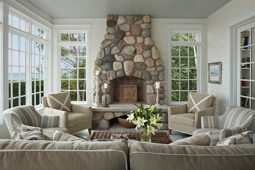 Beach style painted wood floor and gray floor sunroom photo in Other with a standard fireplace and a stone fireplace