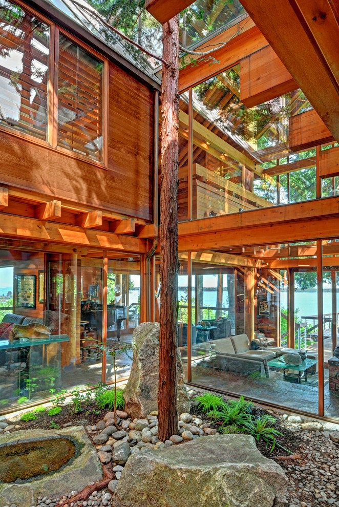 Sunroom - rustic sunroom idea in Seattle with a glass ceiling