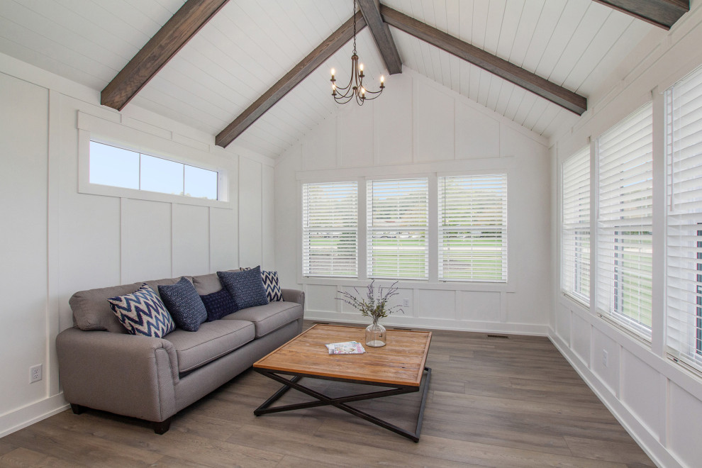 This is an example of a medium sized farmhouse conservatory in Grand Rapids with vinyl flooring, a standard ceiling, brown floors and no fireplace.