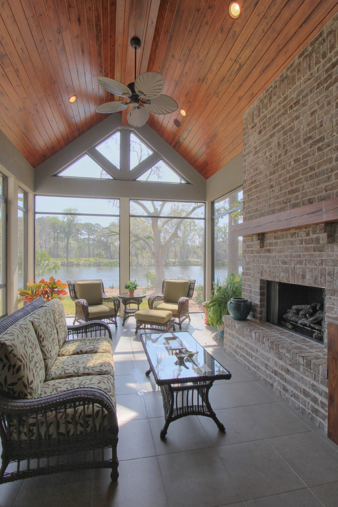 Large elegant concrete floor sunroom photo in Atlanta with a standard fireplace, a brick fireplace and a standard ceiling