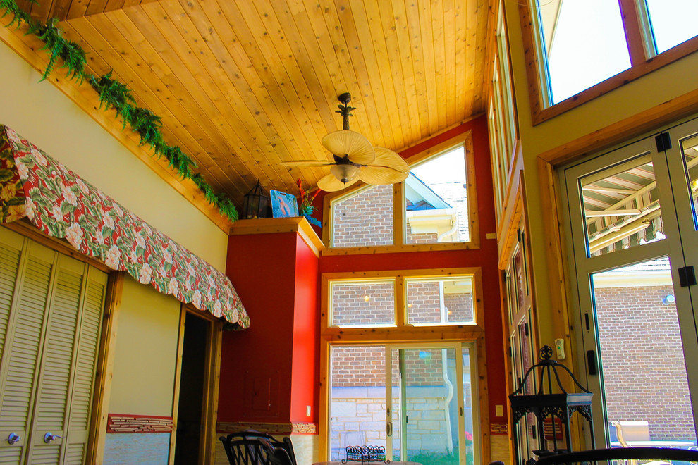 Esempio di una veranda tropicale di medie dimensioni con soffitto classico e pavimento grigio