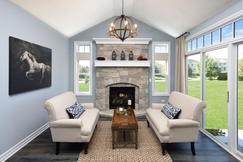 Example of a transitional sunroom design in Chicago with a standard fireplace, a stone fireplace and a standard ceiling